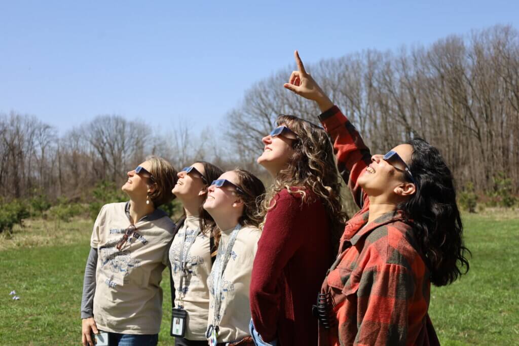 Teachers looking up at the eclipse
