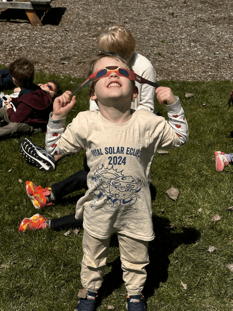 preschooler looking up at the eclipse